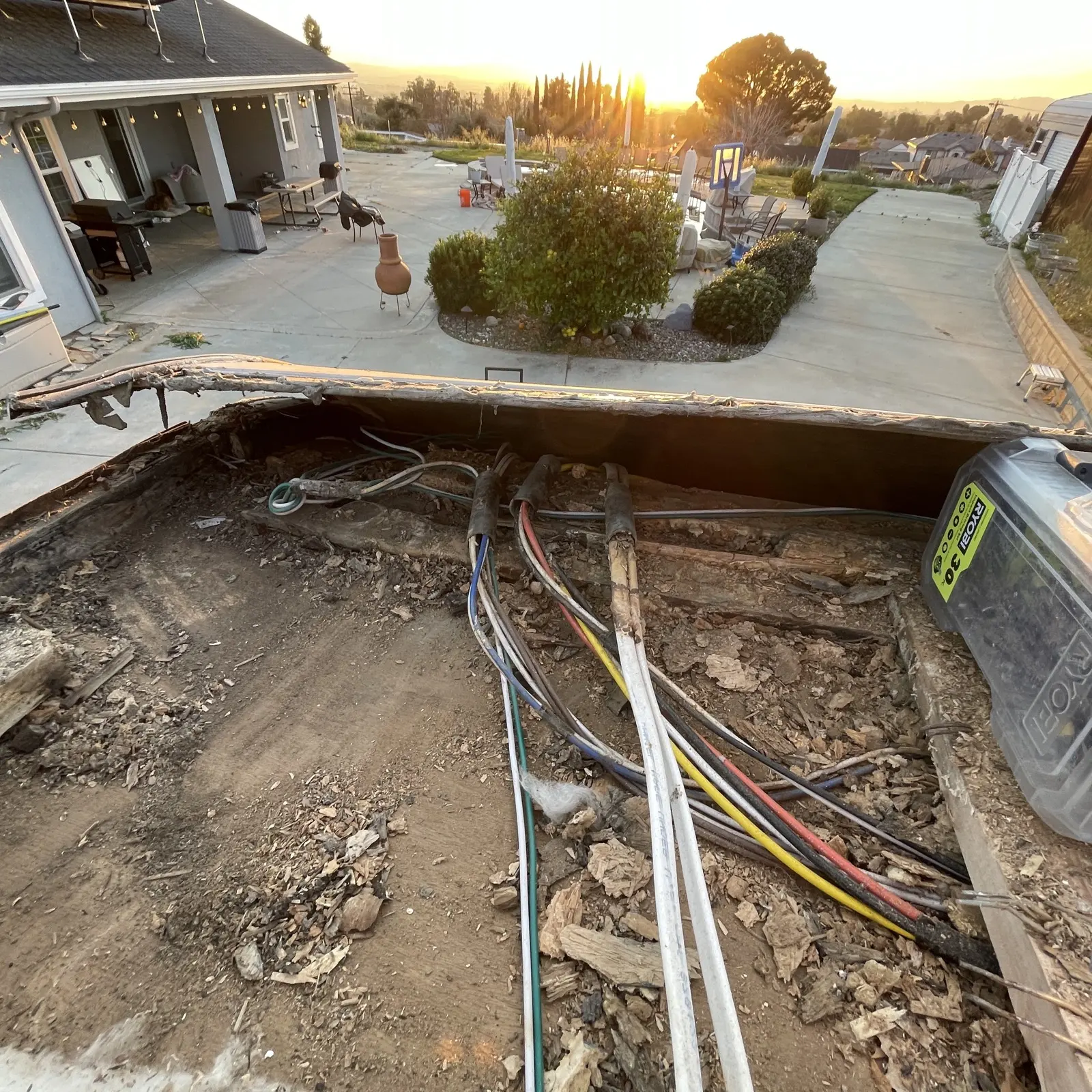 Rotten RV roof deck with wet debris and exposed wiring after the membrane was removed