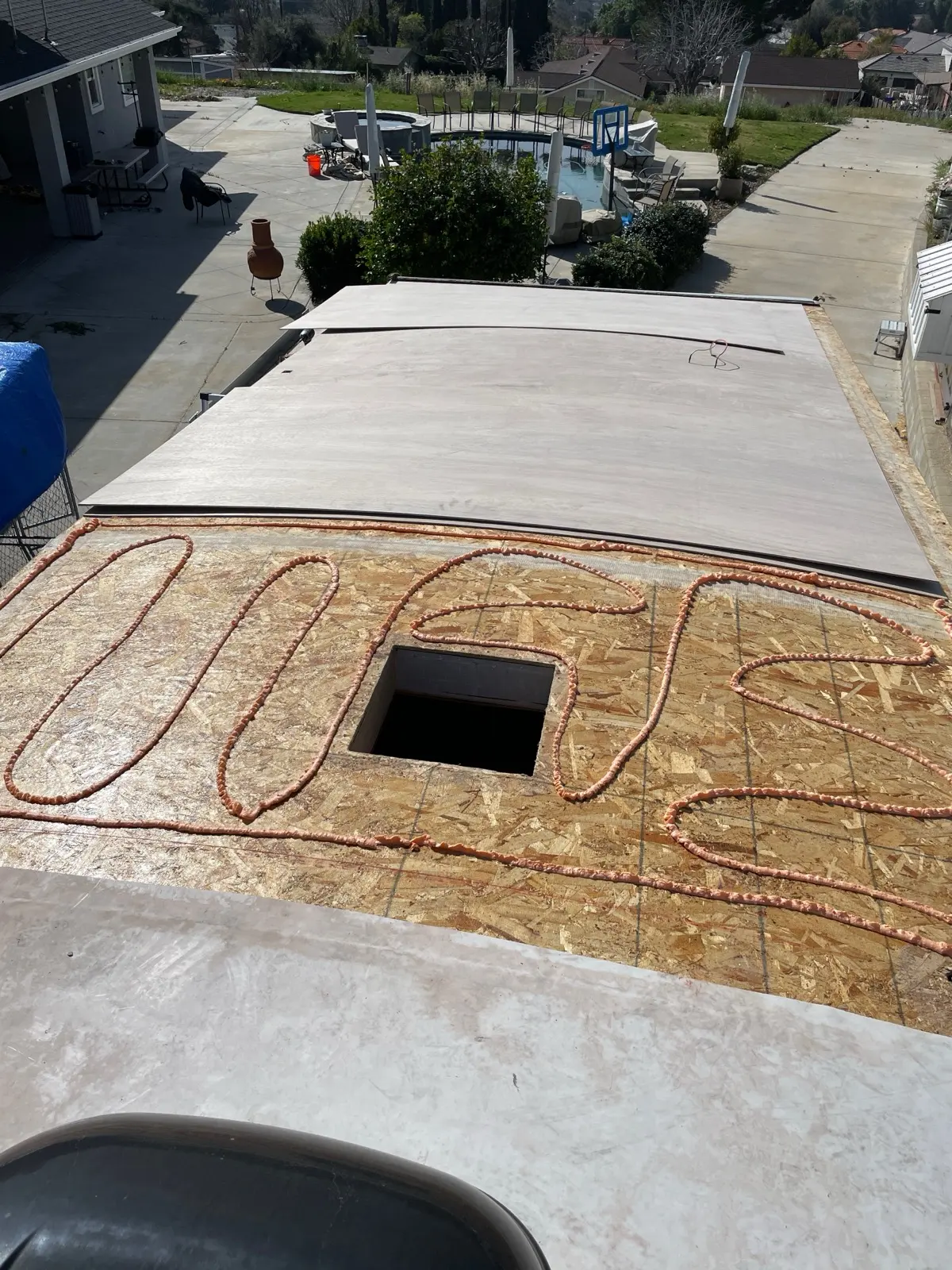 New OSB roof deck with adhesive laid in beads before the TPO membrane