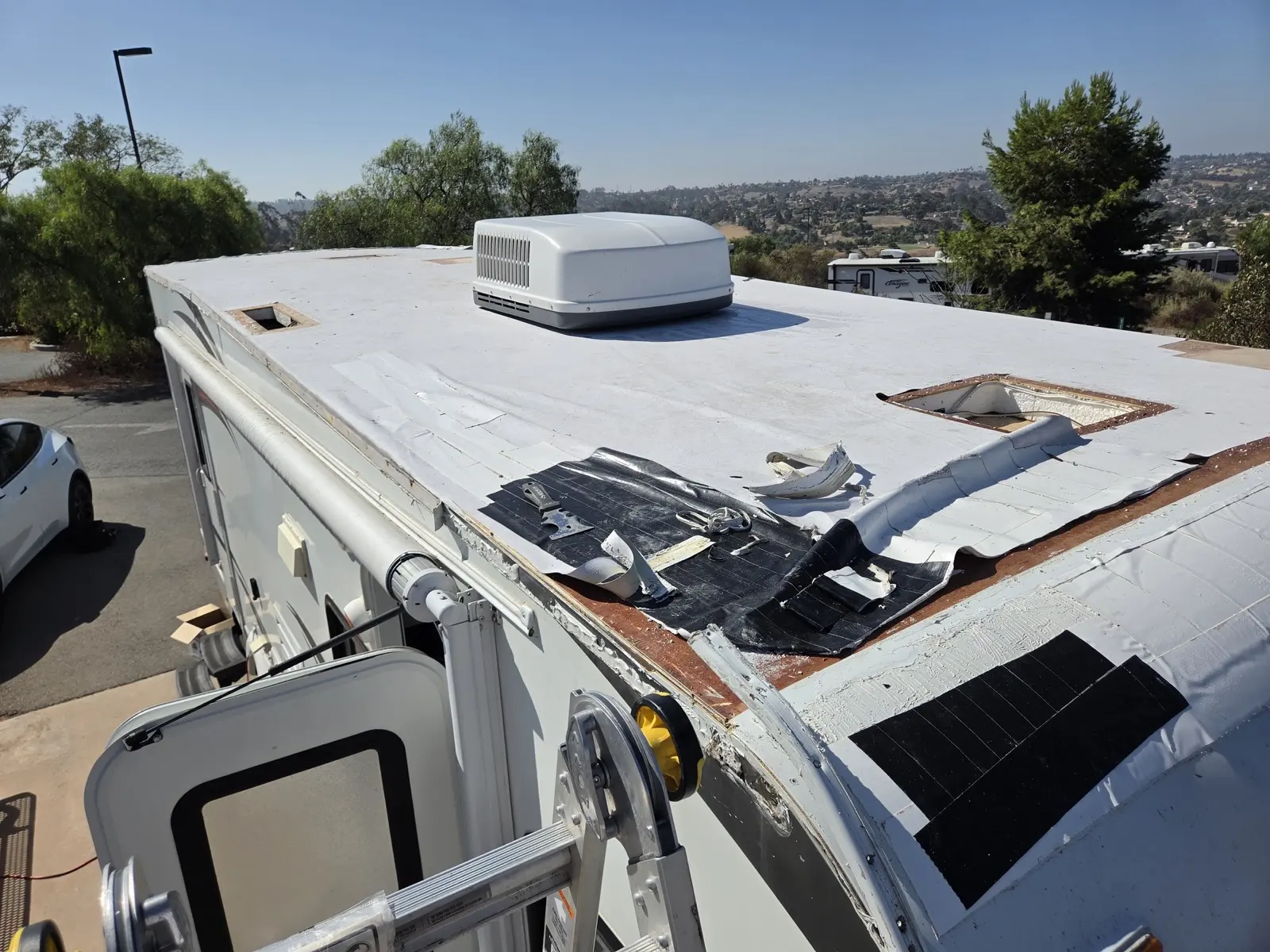 Travel trailer roof during tear-off, old membrane stripped